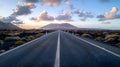 Open Road Leading Towards a Mountain under a Sky with Clouds at Sunset. Scenic Route Landscape. Travel and Freedom Royalty Free Stock Photo