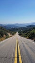 Open road through rolling hills Royalty Free Stock Photo