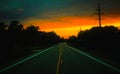 An open road & x28;state route 322& x29; at dusk while facing a sunset in Orwell, Ohio Royalty Free Stock Photo