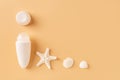 Open roll on antiperspirant deodorant, sea star and shells against pastel orange background. Concept of organic toiletries and