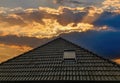 Open roof window in velux style with black roof tiles