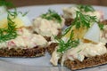 Open rye bread sandwich with boiled egg, dill and cream cheese crab spread