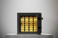 Open safe box, white wall, gold ingots Royalty Free Stock Photo