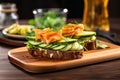 an open sandwich with avocado, smoked salmon, and cucumber