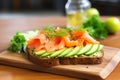 an open sandwich with avocado, smoked salmon, and cucumber