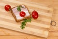 Open sandwich with boiled-smoked pork belly on cutting board