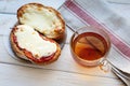 Open sandwich with cheese and cup of tea on wooden table. Breakfast concept Royalty Free Stock Photo