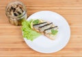Open sandwich with preserved smoked sprats and jar with sprats Royalty Free Stock Photo