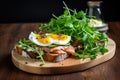 an open sandwich with smoked fish and salad leaves