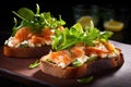 an open sandwich with smoked fish and salad leaves