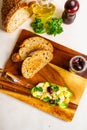 Open sandwich with traditional German potato salad, bread, ingredients on wooden cutting board, top view Royalty Free Stock Photo