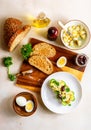 Open sandwich with traditional German potato salad, bread, all ingredients on wooden cutting board, top view Royalty Free Stock Photo