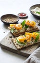 Open sandwiches with cereal bread, yogurt homemade cheese, yellow cherry tomatoes and capers