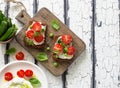 Open sandwiches with cream cheese,cherry tomatoes, green peas and basil close up Royalty Free Stock Photo