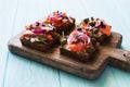 Open sandwiches with salmon, capers, soft cheese , red onions close up