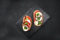 Open sandwiches, with an open sliced sourdough bread sandwich with cherry tomatoes, mini mozzarella, fresh basil, olive Royalty Free Stock Photo