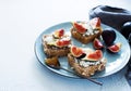 Open sandwiches with soft cheese and figs on a blue plate Royalty Free Stock Photo