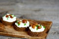 Open sandwiches on a wooden board. Sandwiches with rye bread, soft cheese, mushrooms and green onion Royalty Free Stock Photo