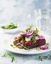 Open sanwich with dark rye bread, beet, marinated herring, pickled cucumber and red onion, smorrebrod