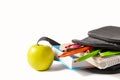 Open school backpack on an white background. Books, a notebook and pencils are sticking out of an open school backpack Royalty Free Stock Photo