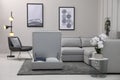 Open section with storage near modular sofa in living room. Interior design