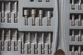 Open set of the interchangeable flat and hexagonal bits different sizes for screwdriver in gray plastic box Royalty Free Stock Photo