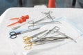 An open set of sterile surgical instruments lies on the table in the operating room. Surgical instruments are scattered Royalty Free Stock Photo