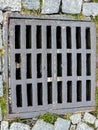 Open sewer manhole on an old paved road.Top view Royalty Free Stock Photo