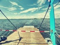 Open side ramp on small car and passenger ferry boat on lake Royalty Free Stock Photo