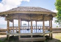 Open-sided beach hut or fale with woven palm leaf roof by waterfront near Pula Cave Pool, Upolu Island, Samoa, South Pacific Royalty Free Stock Photo