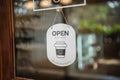 Open sign broad through the door glass bokeh background. OPEN sign board through the glass of store window. text wooden board door Royalty Free Stock Photo