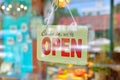 Open sign broad through the glass of window Royalty Free Stock Photo