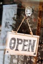 Open sign broad through the glass of window at coffee shop Royalty Free Stock Photo