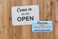 Open Sign On The Front Door Of Business With Please Keep Safe Social Distance And Wear Face Mask