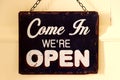 Open sign hanging on a wooden door - Come in we are open Royalty Free Stock Photo