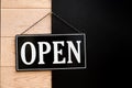 Open sign hanging on wooden wall. Royalty Free Stock Photo