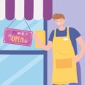 We are open sign, male employee with apron store front door signboard Royalty Free Stock Photo
