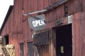 Open sign on red barn