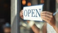 Open sign, restaurant window and hands of person, small business owner or manager with cafe door poster for welcome