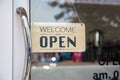 Open sign wooden broad through the glass of window at coffee shop Royalty Free Stock Photo