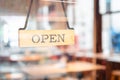 Open sign wooden broad through the glass of window at coffee shop Royalty Free Stock Photo