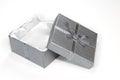 Open silver gift box with ribbon and bow