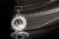 Pocket watch swinging on chain with motion blur trail Royalty Free Stock Photo