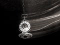 Pocket watch swinging on chain with motion blur trail Royalty Free Stock Photo