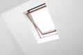 Open skylight roof window and lamps on slanted ceiling in attic room, low angle view Royalty Free Stock Photo