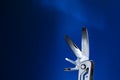 Open source multitool with expanded tools. multitools steel on blue background