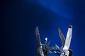 Open source multitool with expanded tools. multitools steel on blue background