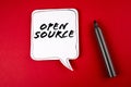 Open Source. Speech bubble and black marker on red background Royalty Free Stock Photo