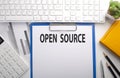 OPEN SOURCE written on the paper with keyboard, chart, calculator and notebook Royalty Free Stock Photo