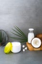 Open spa cream for body skincare and hair with coconut oil, fresh coconuts, palm leaf and bottle with coconut butter on Royalty Free Stock Photo